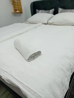a white bed with white sheets and pillows at AURORA in Visoko