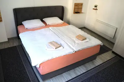 a bed in a room with two towels on it at AURORA in Visoko