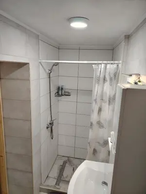 a bathroom with a shower and a toilet and a sink at AURORA in Visoko