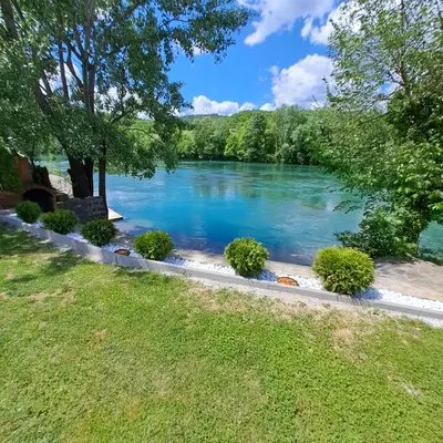 a view of a river with trees and grass at Kuća za odmor Unski Raj in Rudice