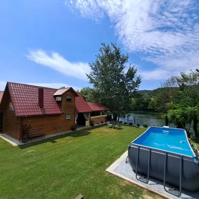 a house with a swimming pool in the yard at Kuća za odmor Unski Raj in Rudice