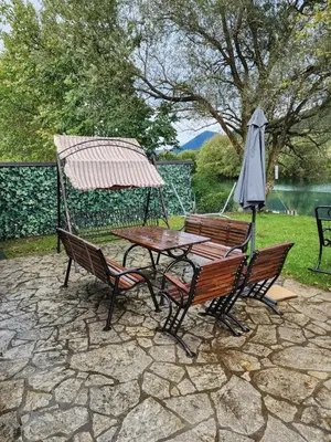 a table and chairs and an umbrella on a patio at River Homes Bihac in Bihać