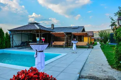 a backyard with a swimming pool and a house at River Homes Bihac in Bihać
