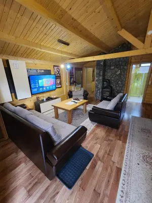 a living room with a large couch and a tv at River Homes Bihac in Bihać