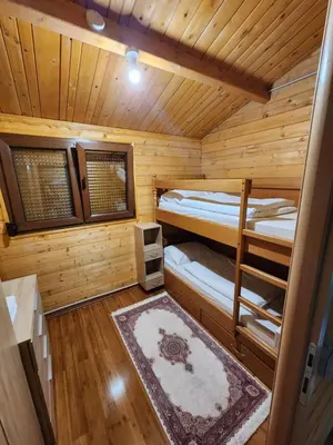 a room with two bunk beds in a log cabin at River Homes Bihac in Bihać