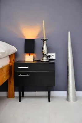 a bedroom with a bed and a nightstand with a lamp at Stela1 in Drvar