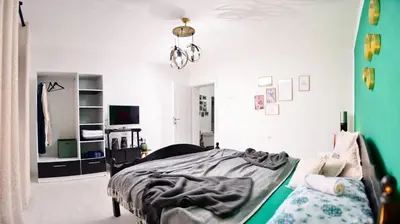 a bedroom with a bed and a chandelier at Stela1 in Drvar