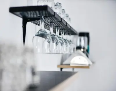a row of wine glasses hanging on a wall at Stela1 in Drvar