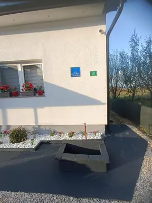 a building with a bench in front of it at Apartman Cirkic in Sanski most