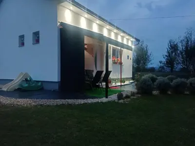 a house with lights on the side of it at Apartman Cirkic in Sanski most