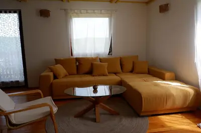 a living room with a couch and a table at Bosnian Mountain Retreat in Prijedor