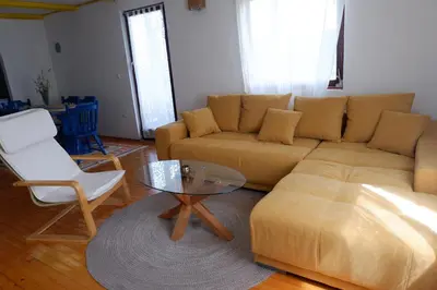 a living room with a couch and a table at Bosnian Mountain Retreat in Prijedor