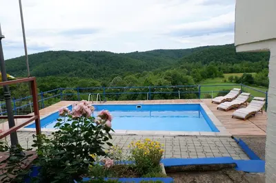 a swimming pool on the deck of a house at Bosnian Mountain Retreat in Prijedor