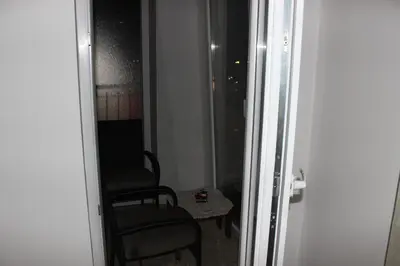 a room with two chairs and a table and a mirror at Apartman Romana in Doboj