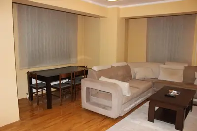 a living room with a couch and a table at Apartman Romana in Doboj