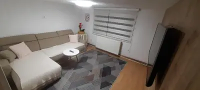 a living room with a couch and a window at Sunset Apartment in Visoko
