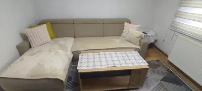 a living room with a couch and a table at Sunset Apartment in Visoko