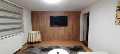 a living room with a television on a wall at Sunset Apartment in Visoko