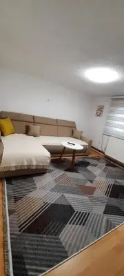 a living room with a couch and a rug at Sunset Apartment in Visoko