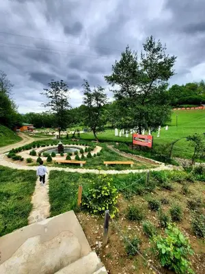 a person walking down a path in a park at Sunset Apartment in Visoko
