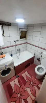 a bathroom with a tub and a toilet and a sink at Sunset Apartment in Visoko
