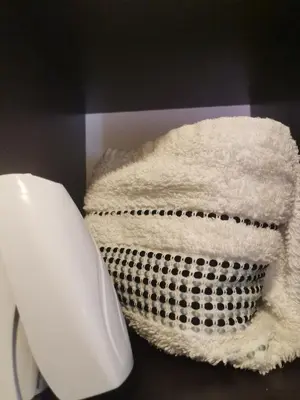 a pile of towels sitting next to a computer mouse at Jelly Apartment in Visoko