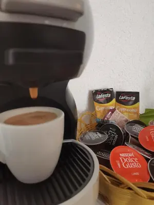 a coffee maker is making a cup of coffee at Jelly Apartment in Visoko