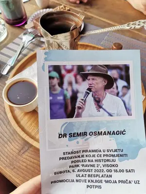 a person holding a card with a microphone on a table at Jelly Apartment in Visoko