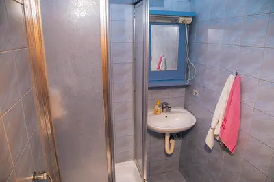 a bathroom with a shower and a sink at Jezero Laminci in Bosanska Gradiška