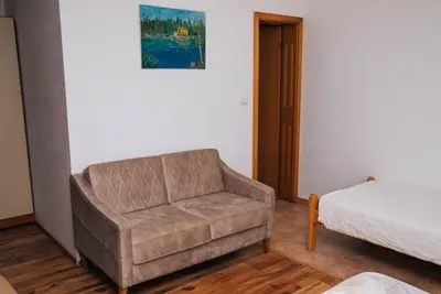 a living room with a couch and a bed at Jezero Laminci in Bosanska Gradiška