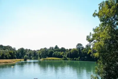 a large lake with trees in the background at Jezero Laminci in Bosanska Gradiška