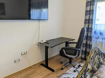 a desk and a chair in a room at Apartmani Hrastik 1 in Bihać