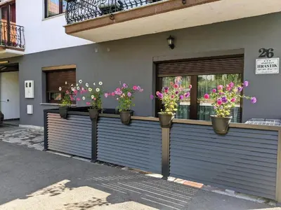 a row of potted flowers on a building at Apartmani Hrastik 1 in Bihać