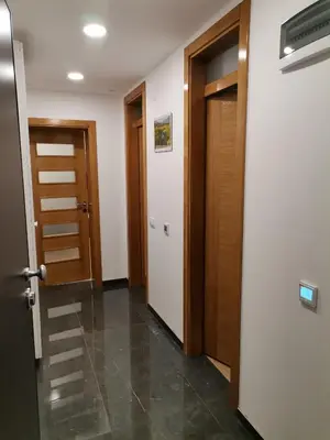 an empty hallway with two doors and a tile floor at City Break Apartment in Banja Luka