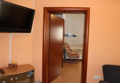 a door to a room with a television and a chair at Holiday Home Uma in Visoko