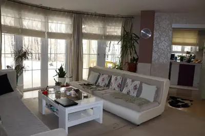 a living room with a white couch and a table at Holiday Home Uma in Visoko