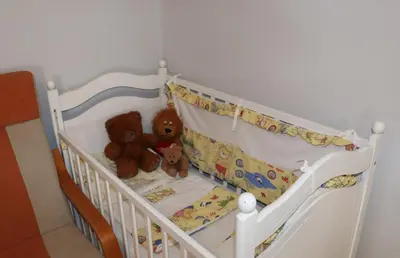 two teddy bears are sitting in a crib at Holiday Home Uma in Visoko