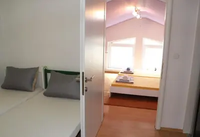 a small bedroom with a bed and a window at Holiday Home Uma in Visoko