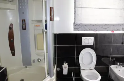 a bathroom with a toilet and a tub and a sink at Holiday Home Uma in Visoko