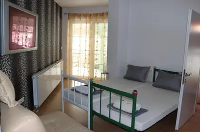 a small room with a bunk bed and a couch at Holiday Home Uma in Visoko