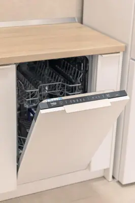 an open dishwasher in a kitchen with a counter top at Drobac apartment in Banja Luka