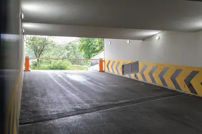 an empty parking lot with a ramp in a parking garage at Drobac apartment in Banja Luka
