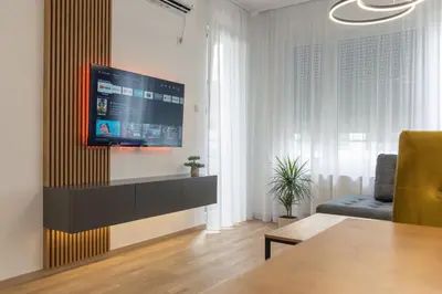 a living room with a flat screen tv on a wall at Drobac apartment in Banja Luka