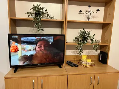 a flat screen tv sitting on top of a cabinet at Titanik Tuzla in Tuzla