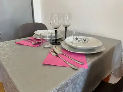 a table with plates and wine glasses on it at Titanik Tuzla in Tuzla