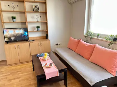 a living room with a couch and a tv at Titanik Tuzla in Tuzla