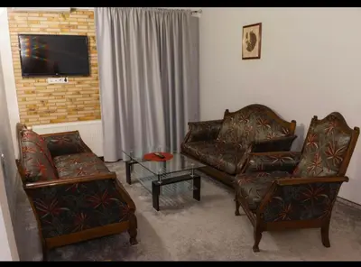 a living room with two chairs and a tv at Apartmani i sobe Centar Bugojno in Bugojno