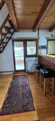 a living room with a rug on a wooden floor at Dream weekend house in Visoko