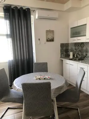 a kitchen with a table and chairs in a kitchen at Gracia in Jajce