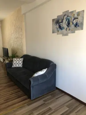 a black couch in a living room with a laptop at Gracia in Jajce